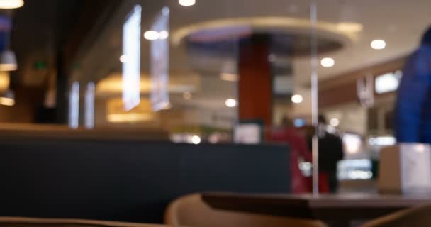 Anonymous crowd of people walking along cafe window. Shallow depth of field. People blurred footage. Vintage grading. — Stock Video