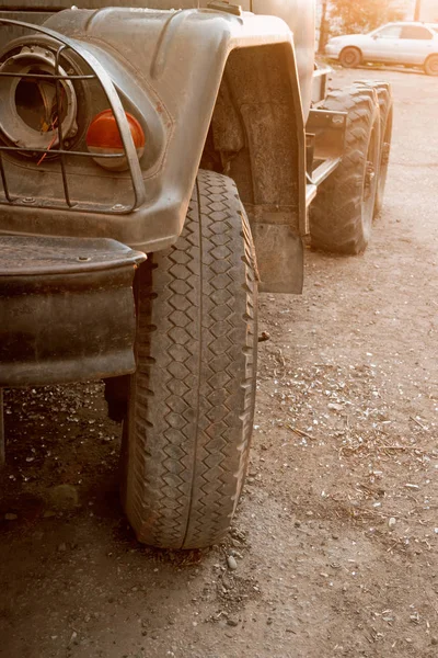 An old military green trucks tire in the street backlit image — Stock Photo, Image