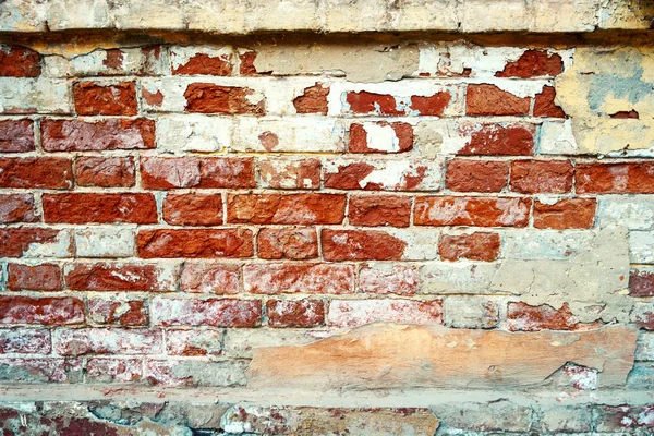 Un vieux mur de briques. Grunge fond de mur de briques altérées avec plâtre blanc sur la texture gros plan — Photo