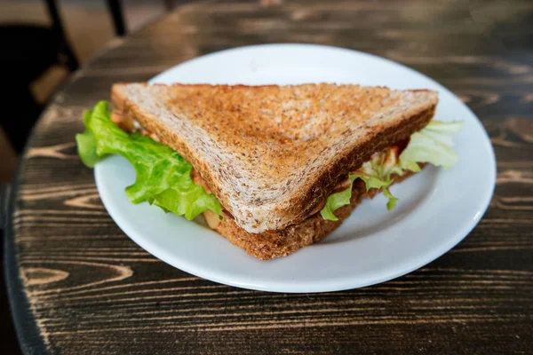 Angle view of triangle clubhouse sandwich on plate — Stock Photo, Image