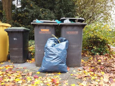 Bonn Almanya, 12 Kasım 2019: Sonbahar caddesinde çöp bidonları servis elemanlarını bekliyor