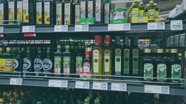 Bonn, Germany - 14 of Dec., 2019: interior shot of REWE supermarket in Bonn POV view. Many types of vegetable oil stands on the shelves - coconut, rapeseed, pumpkin and others — Stockvideo