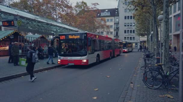 Bonn Germany, 23 Dec. 2019: Buses wait for departure at the stop, and bikes are parked opposite — Stock Video