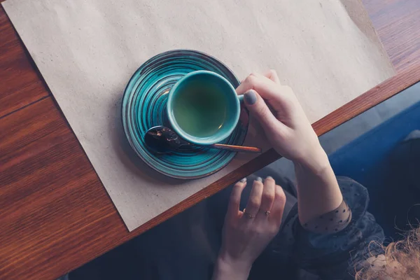 View from above on the girl at the table with a cup of coffee, a copyspace — Stock Photo, Image