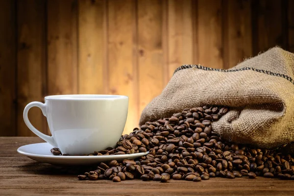 Still life with coffee beans and old coffee mill on the wooden background — Stock Photo, Image