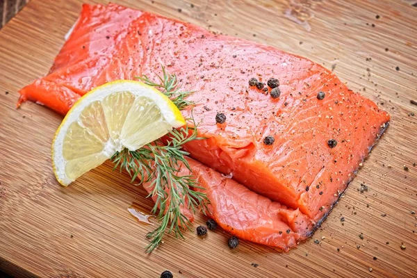 Peixe de salmão com ervas frescas, limão e pimenta — Fotografia de Stock