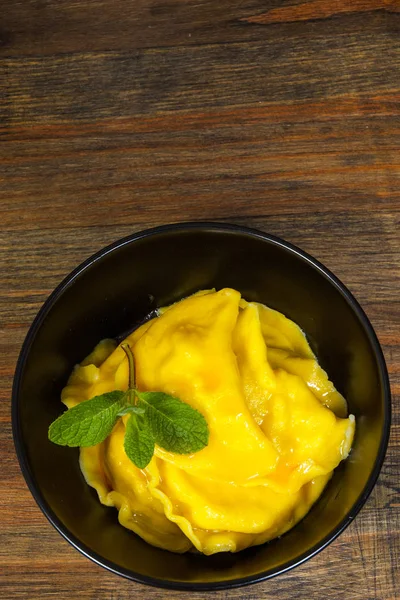 Sweet pumpkin ravioli with banana on a wooden background. with copy space. top view — Stock Photo, Image