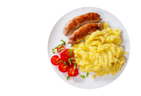 Fried meat sausages with mashed potatoes and vegetables salad in a plate. top view. isolated on white — Stock Photo, Image