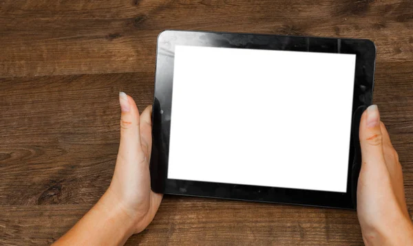 Woman's hand holding black tablet pc with blank white screen on a wooden background. with copy space. top view — Stock Photo, Image