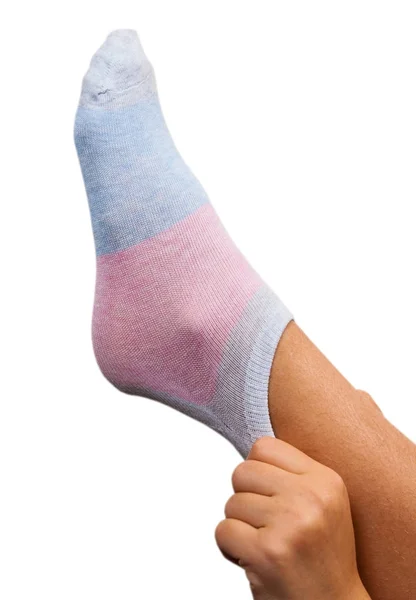 Woman dresses a sock on a foot. isolated on white — Stock Photo, Image