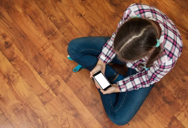 Menina Jeans Senta Chão Madeira Segurando Smartphone Conceito Vida Adolescente — Fotografia de Stock