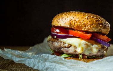 ahşap masa burger. koyu arka plan üzerinde kopya alanı ile.
