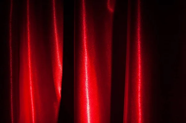 Part of a red curtain. Smooth elegant red silk or satin luxury cloth texture can use as abstract background. Luxurious valentines day background design