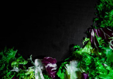 çeşitli taze salata marul, radicchio ve roket ile kopya alanı koyu ahşap zemin üzerine bırakır. Üstten Görünüm