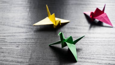 Kopya alanı ile darkwooden arka plan üzerinde renkli origami bir grup vinç