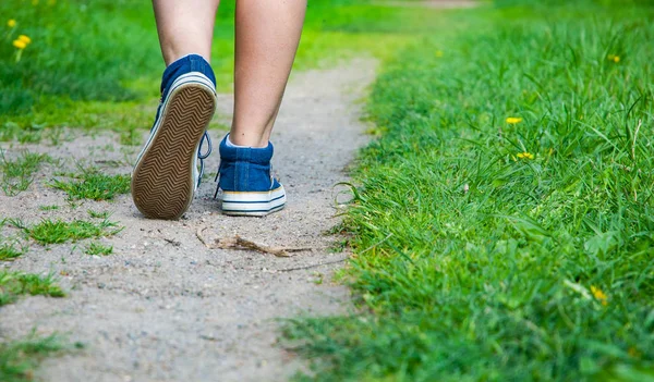 Walking Women Leg Jeans Sneaker Shoes Road Green Grass Stock Photo