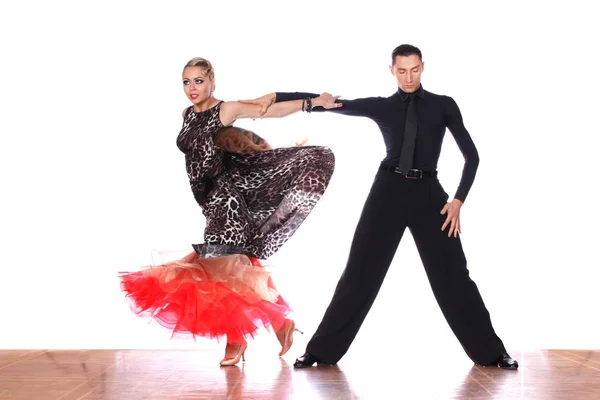 Latino dancers in ballroom against white background — Stock Photo, Image