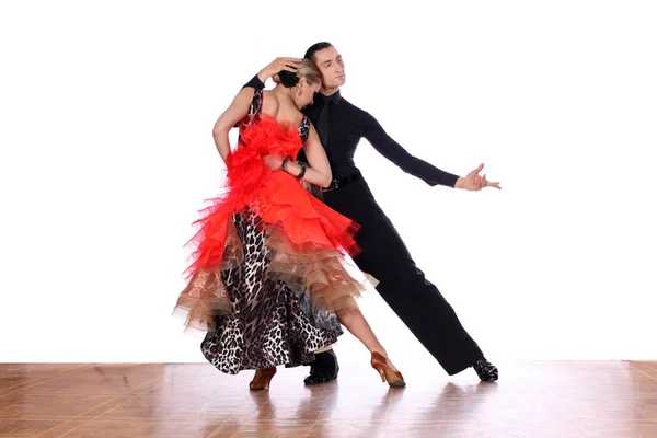 Latino dancers in ballroom against white background — Stock Photo, Image