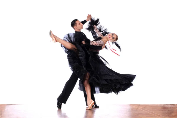 Latino dancers in ballroom against white background — Stock Photo, Image