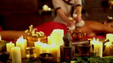 Young woman have hot poultice massage in spa salon. 4k.