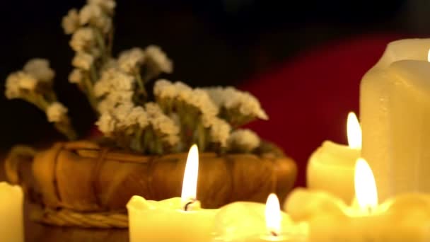 Still life with burning candles and massage herbs. Background girl gets massage. — Stock videók