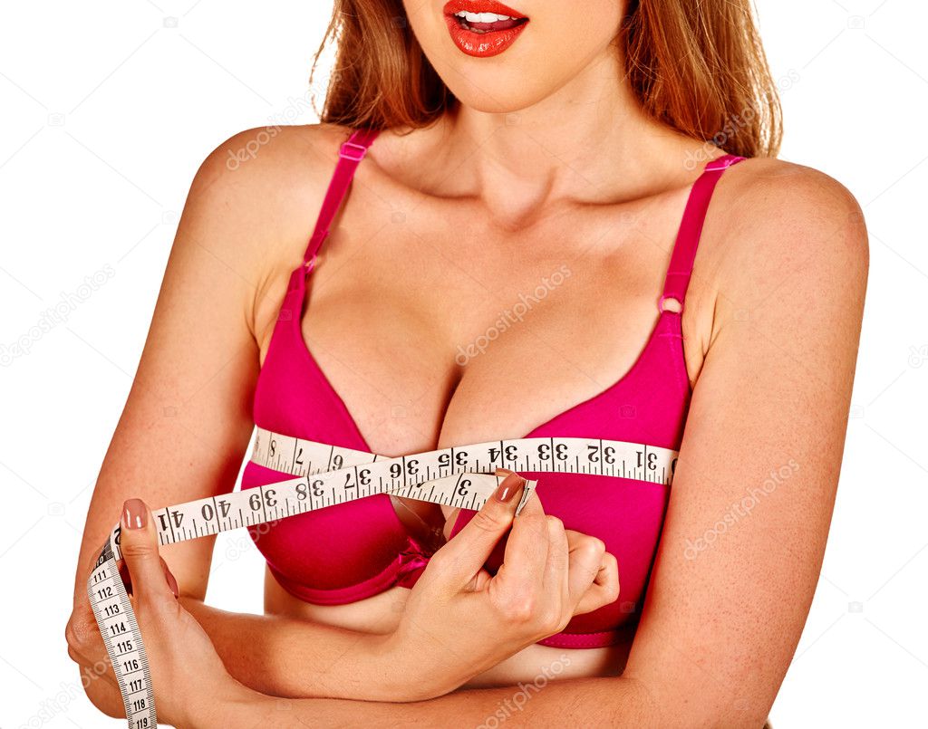 Girl in lingerie measures her breast measuring tape.