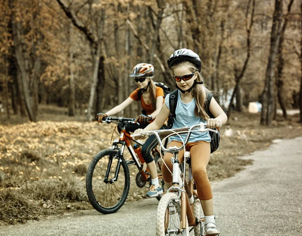 Bikes girls with rucksack cycling on bicycle. Toned sepia image. — Φωτογραφία Αρχείου