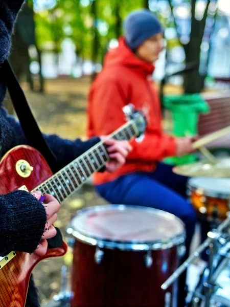 Male buskers on autumn outdoor play guitar. — ストック写真