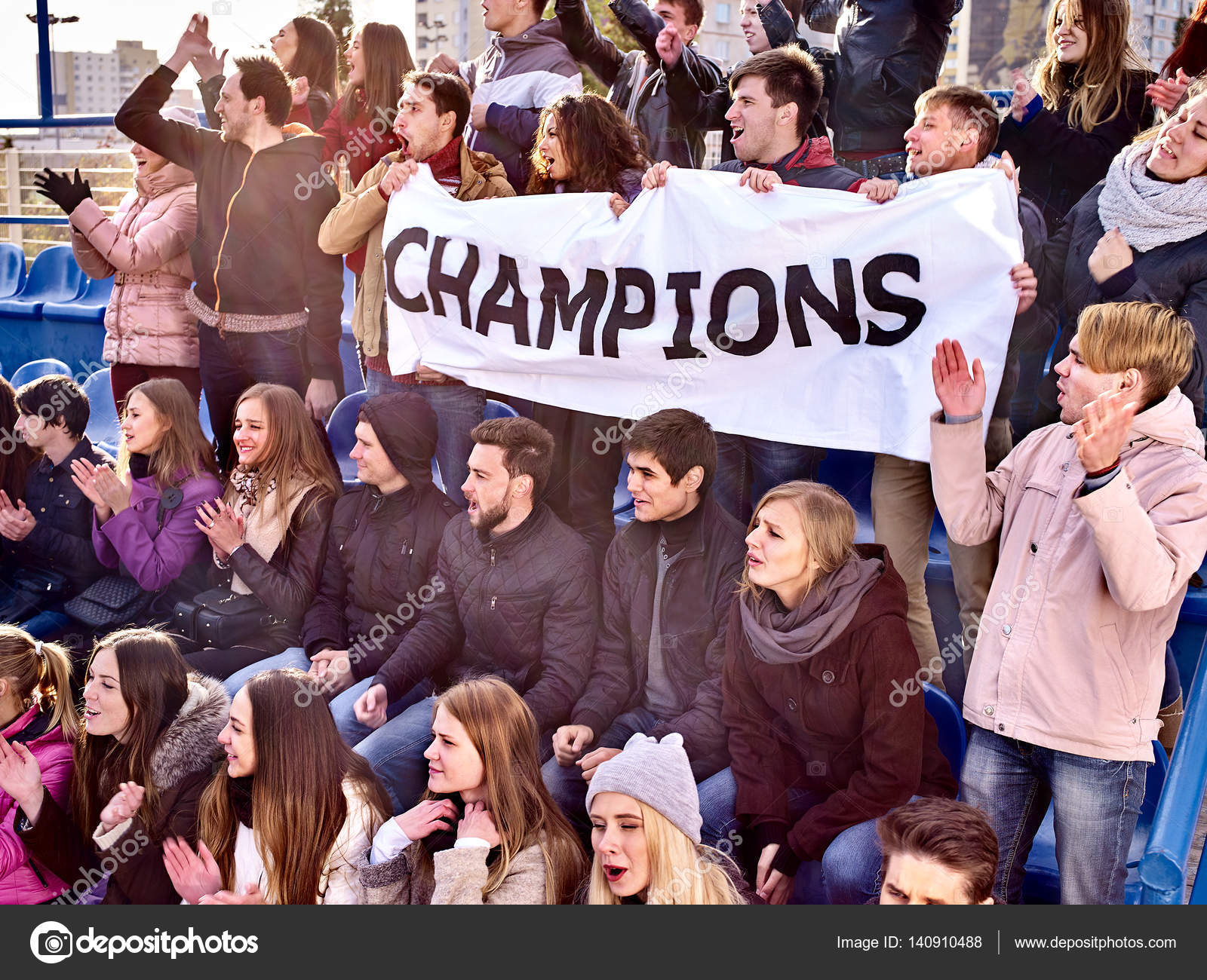 Cheering fans in stadium holding champion banner. — Stock Photo © poznyakov 140910488
