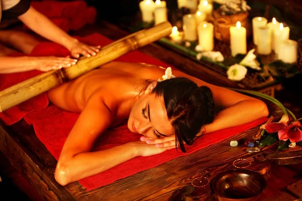 Bamboo massage of woman in spa salon. Interior oriental therapy . — Stock Photo, Image