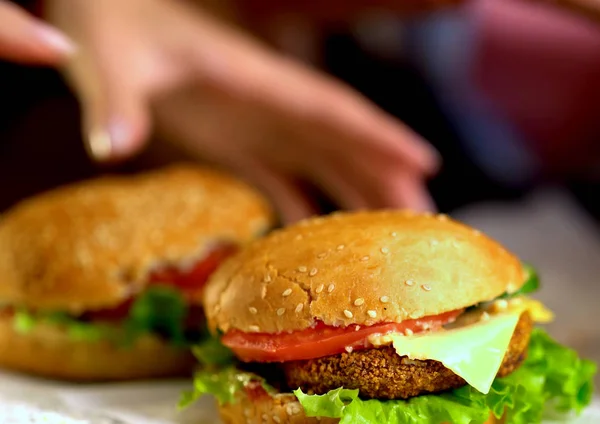 Hambúrguer fast food com presunto na tábua de madeira. Fundo desfocado . — Fotografia de Stock