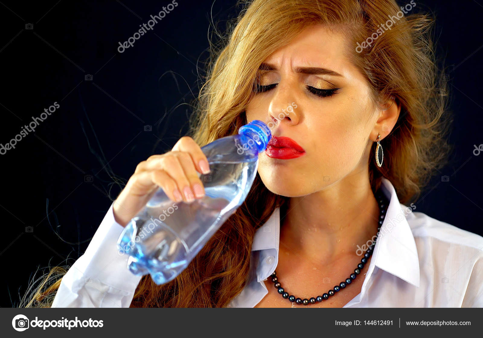 Sensitive teeth woman drinking cold water from bottle. Sudden toothache