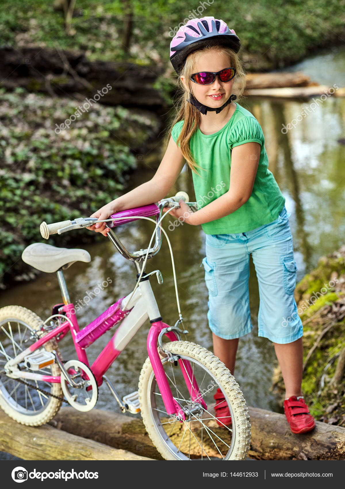 Bicycle children with ladies bikes in summer park. Stock Photo by