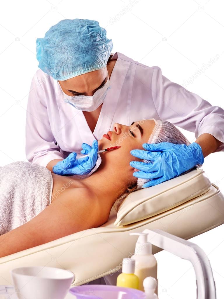 Dermal fillers of woman in spa salon with beautician.