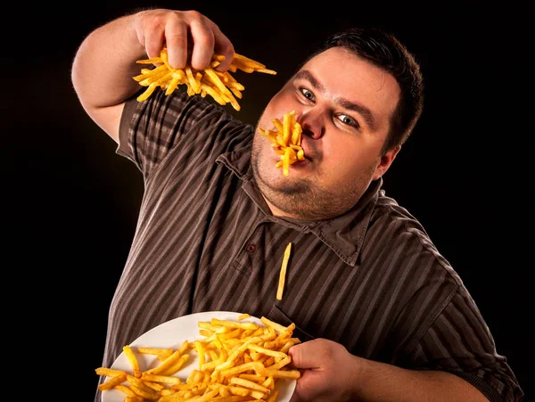 Fat man eating fast food french fries for overweight person. — Stock Photo, Image