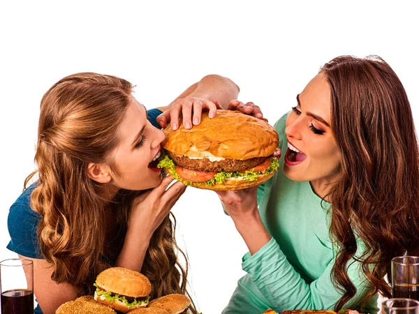 Mulheres a comer fast food. Gils comer hambúrguer com presunto  . — Fotografia de Stock