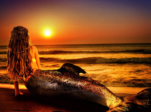 Woman mermaid dreams on sea sandy beach. Fairy girl