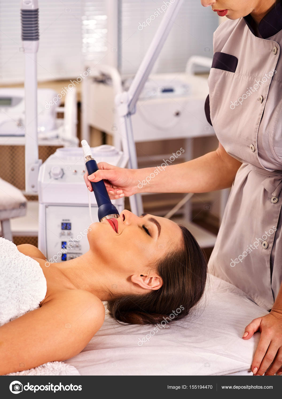 Ultrasonic facial treatment on ultrasound man face machine. Stock Photo by ©poznyakov 155194470