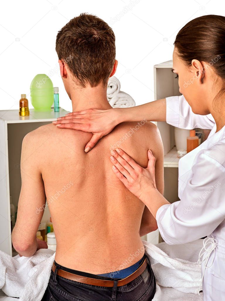 Shoulder and neck massage for woman in spa salon.