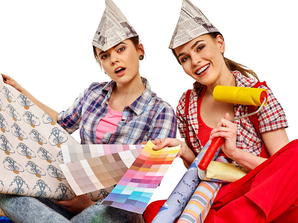 Repair home women holding color guide for wallpaper.
