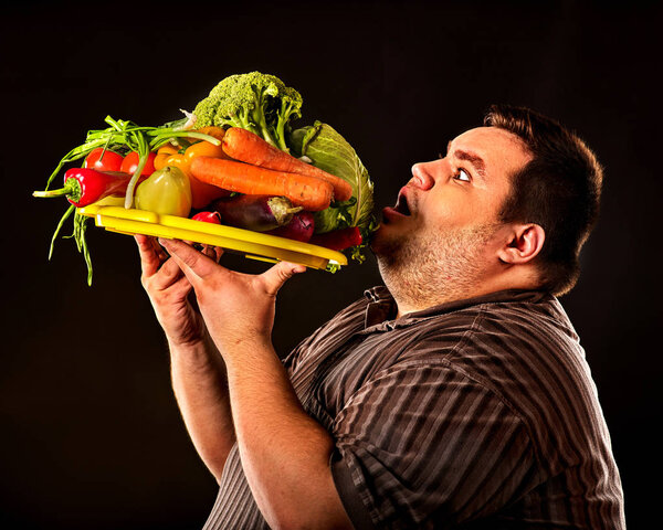 Diet fat man eating healthy food . Healthy breakfast with vegetables.