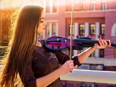 Woman perform music on violin park outdoor. Girl performing jazz . clipart