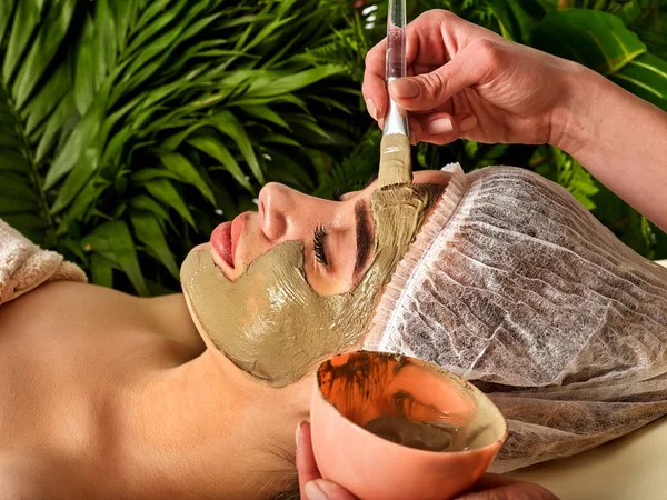 Mud facial mask of woman in spa salon. Face procedure. — Stock Photo, Image