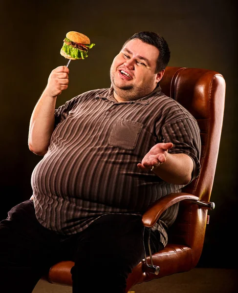デブ男を食べるファーストフードのハンバーグ。太り過ぎの人の朝食. — ストック写真