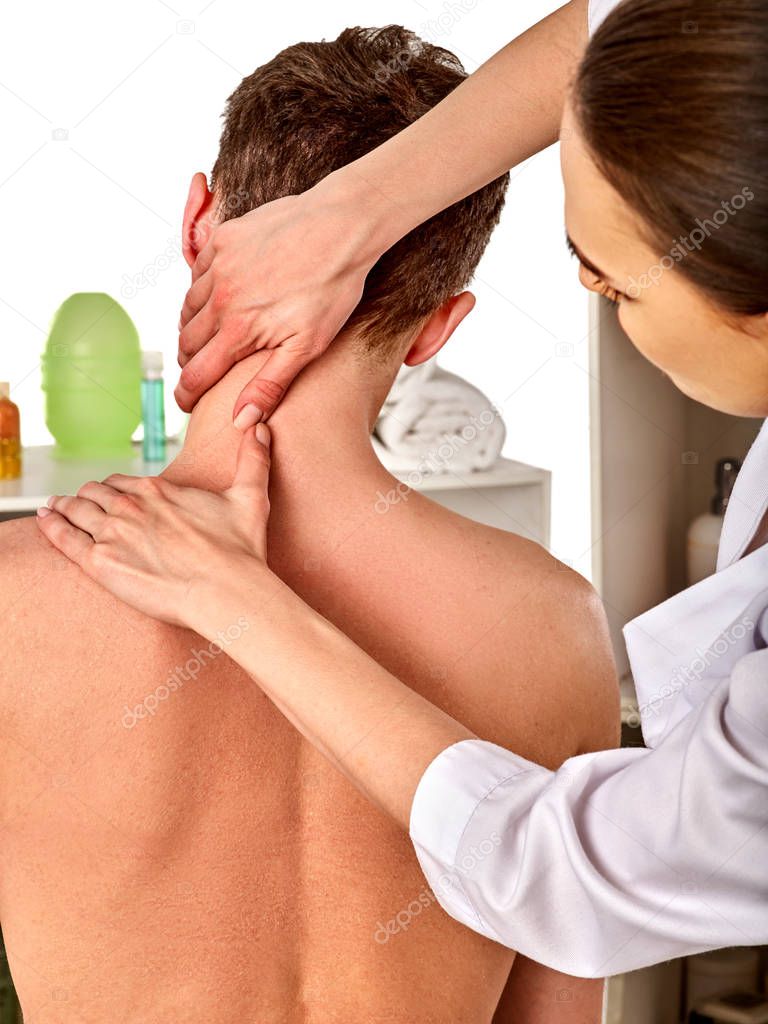 Shoulder and neck massage for woman in spa salon.