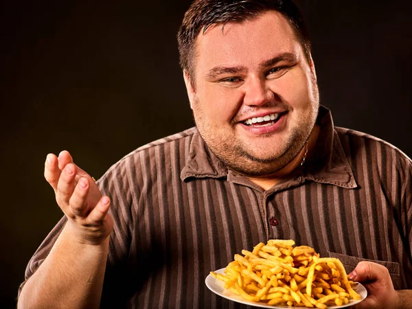 Dicker Mann isst Fast Food Pommes für Übergewichtige. — Stockfoto