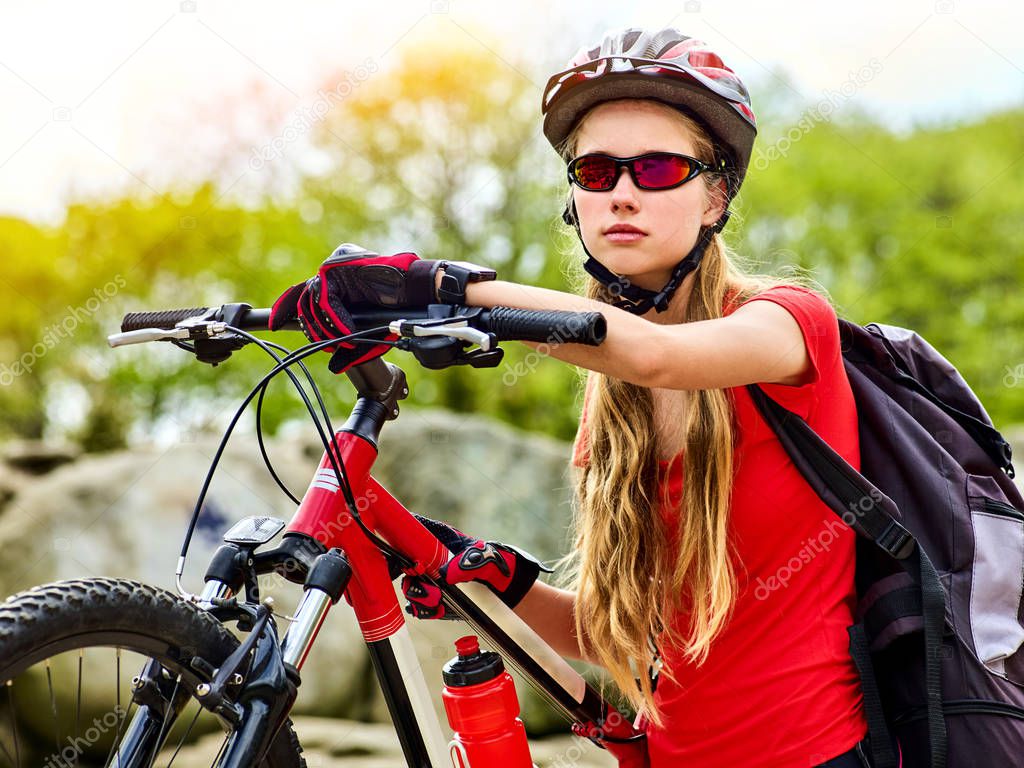 Woman traveling bicycle summer park. Girl with smart watch traveling