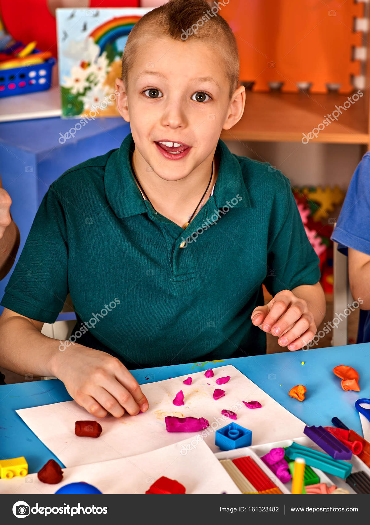 Plasticine modeling clay in children class. kids together play dough and  mold from plasticine in kindergarten or preschool. Group of four people.  Teaching modeling. Stock Photo