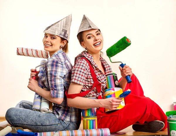 Reparación de las mujeres del hogar celebración Banco con pintura para el papel pintado . — Foto de Stock