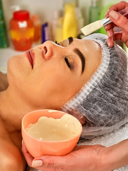 Collagen face mask. Facial skin treatment. Woman receiving cosmetic procedure.